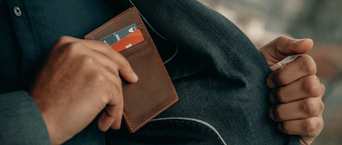a man holding a wallet in his pocket